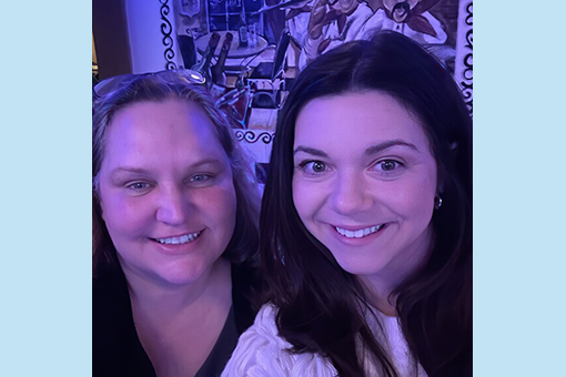 barbbrittany Two professional women smiling confidently in front of a whiteboard with planning notes.